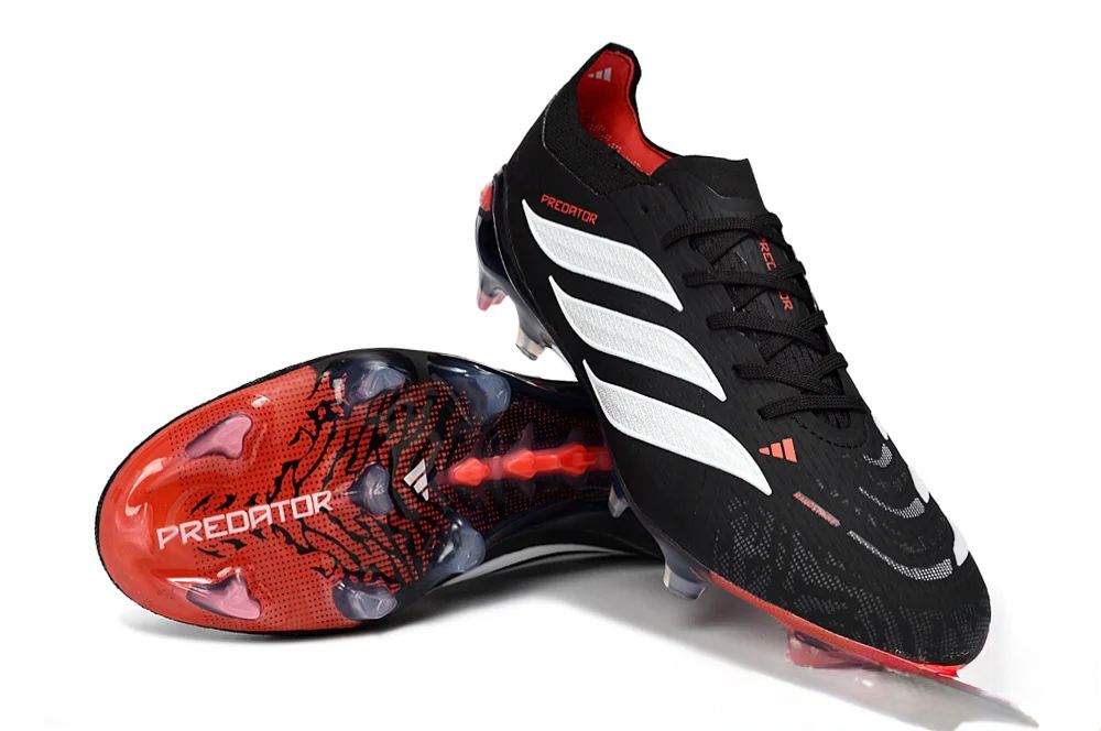 ea419154-8081-4512-993c-3ec2dc85f215 | UAE SPORT STORE Black Adidas Predator soccer cleats with white stripes and red accents; studded outsole shown from-side angle, suitable for football.