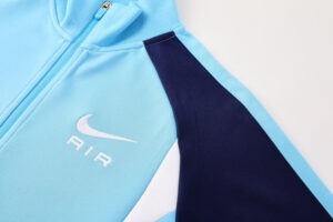 eb1e7e93 | UAE SPORT STORE Light blue athletic jacket with a white AIR logo on the chest and a dark navy sleeve panel, zipper front