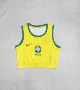 Yellow Brazil crop-top jersey with green trim, featuring the CBF crest, Nike swoosh, and 'BRASIL' text on the front