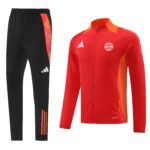 Black athletic pants with orange side stripes shown next to a red training jacket featuring a FC Bayern München crest and orange accents.