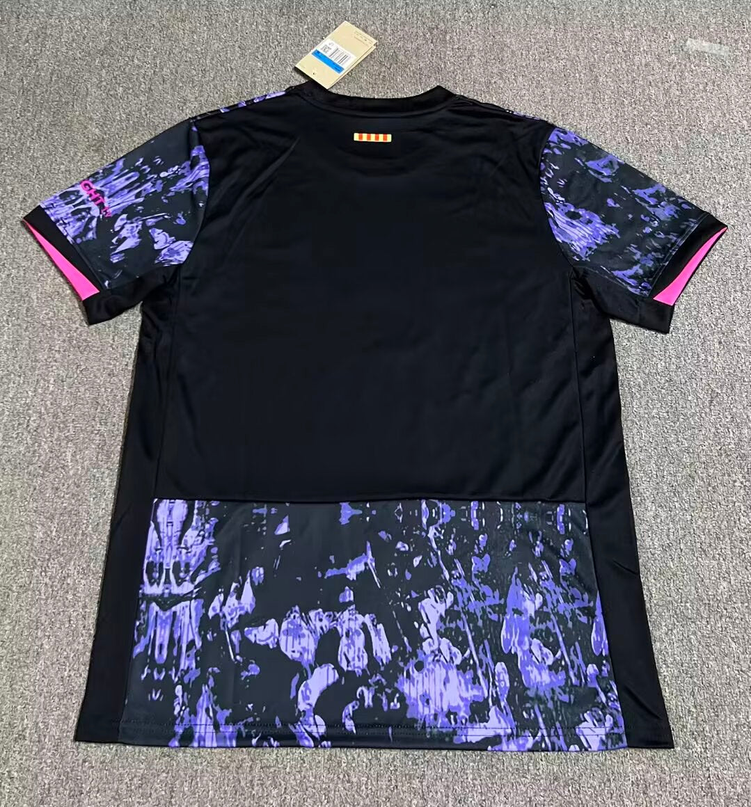 ee614a4c | UAE SPORT STORE Black athletic shirt with purple marbled sleeves and a purple-patterned lower panel, pink trim at sleeve ends, tag attached at the collar area.