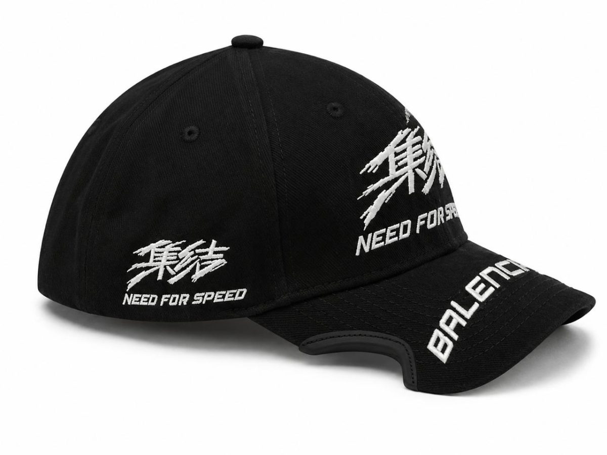 Black cap with white embroidery reading 'Need for Speed' on the side and 'BALENCE' on the brim, plus an abstract white stitch design on the crown.