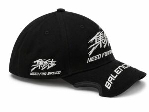 Black cap with white embroidery reading 'Need for Speed' on the side and 'BALENCE' on the brim, plus an abstract white stitch design on the crown.