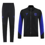 Black tracksuit: zip-front jacket with blue sleeve panels and FC Barcelona crest, paired with black jogger pants.