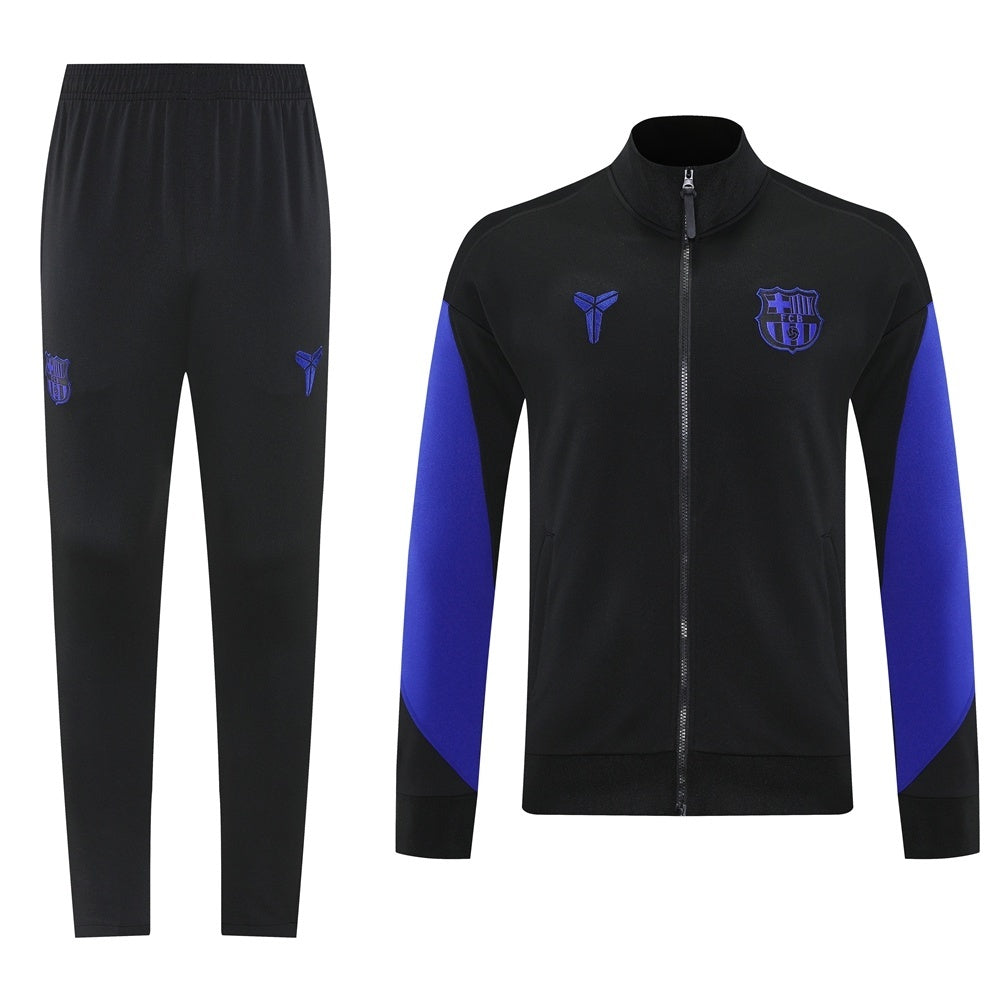 ef30edbf Black tracksuit: zip-front jacket with blue sleeve panels and FC Barcelona crest, paired with black jogger pants.