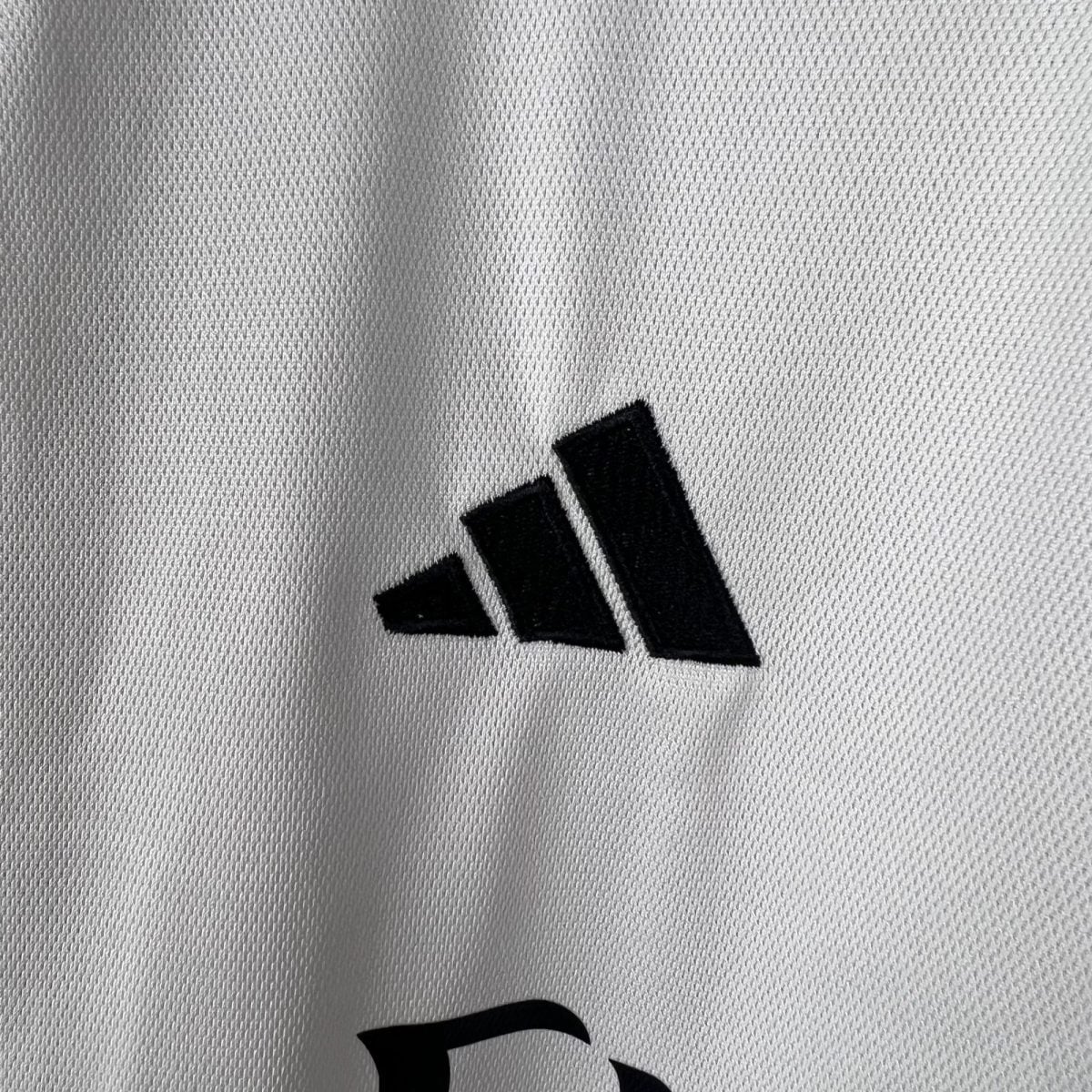 Close-up of light gray textured fabric with a black diagonal stripe pattern.
