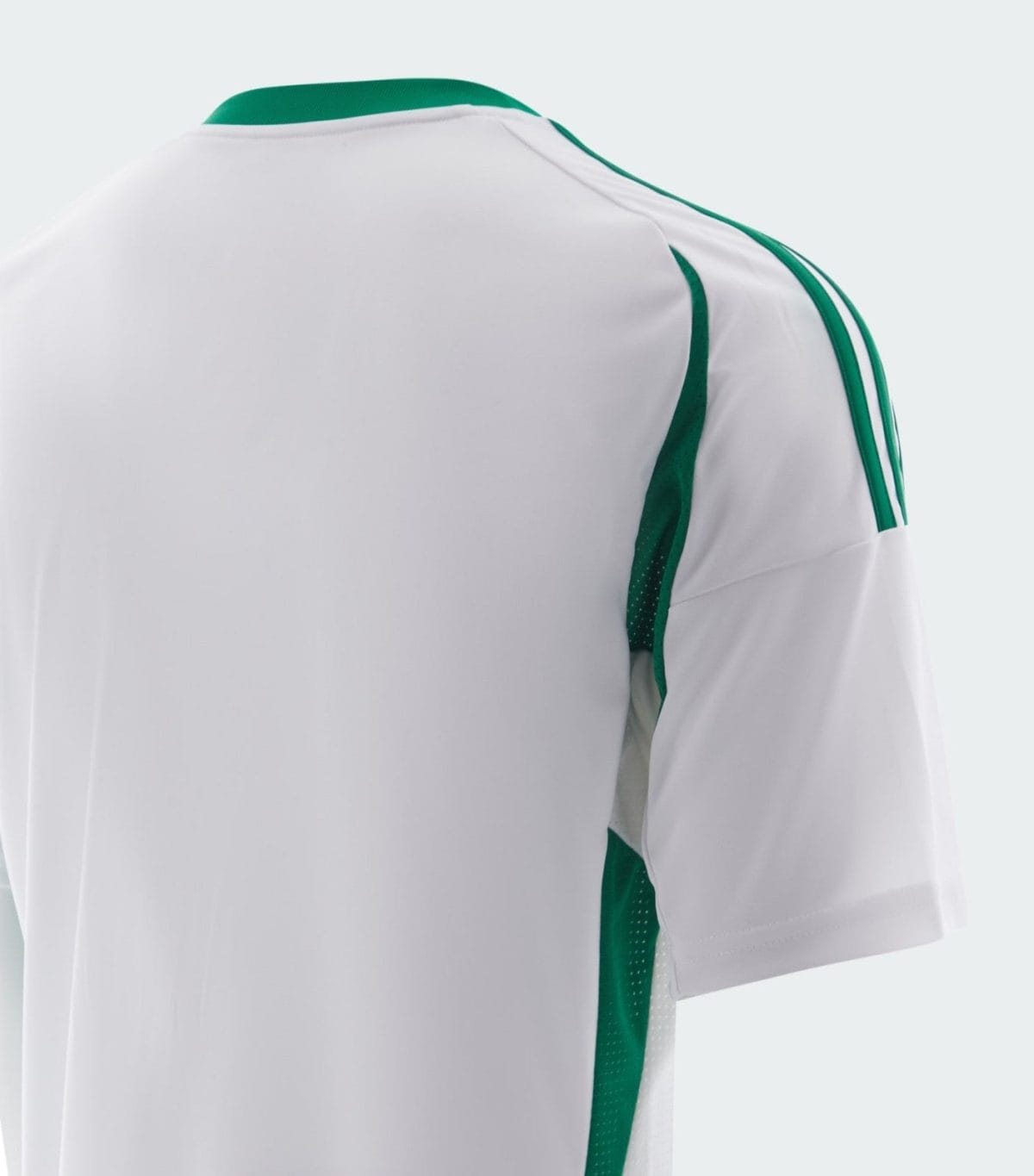 White athletic jersey with green piping along the shoulder and side panels (close-up).] ,