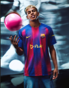 erg | UAE SPORT STORE Young man in a Barcelona jersey juggling a pink soccer ball indoors.
