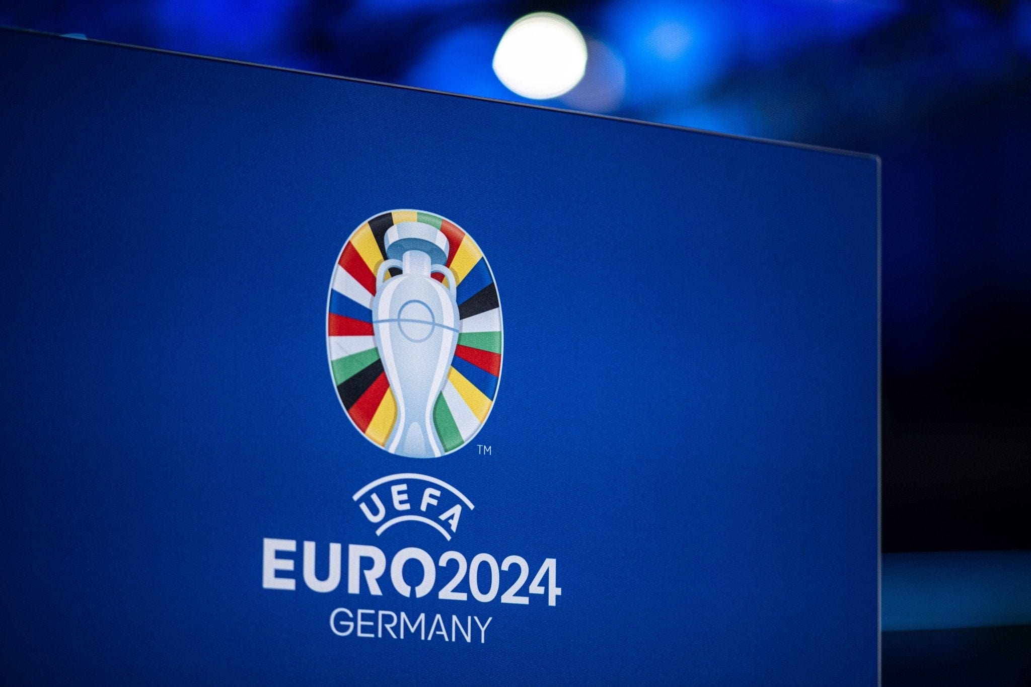 Blue banner featuring the UEFA EURO 2024 logo with a colorful circular emblem on a blue background, 'GERMANY' visible beneath.