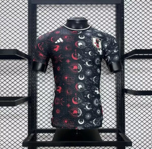 Black Japan football jersey with red and white celestial patterns on a mannequin, featuring a Japan crest on the chest.