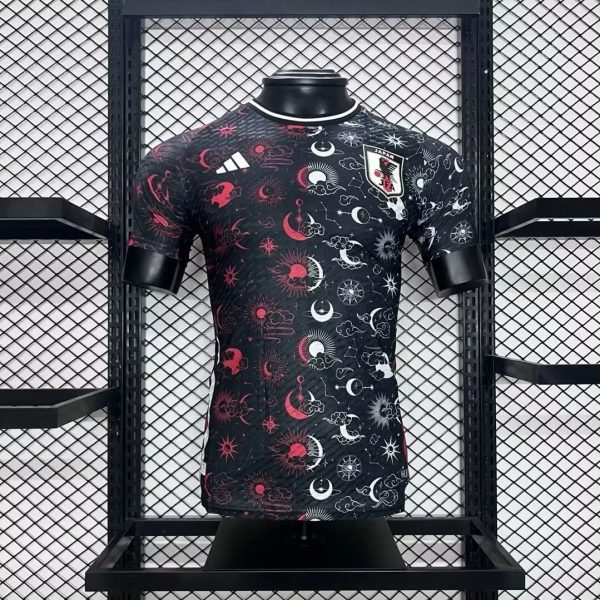 Black Japan football jersey with red and white celestial patterns on a mannequin, featuring a Japan crest on the chest.