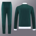 Green tracksuit set: long-sleeve top with white cuffs and hem, matching green jogger pants.