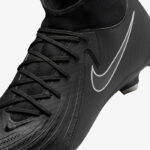 Black Nike soccer cleat with laced upper and white swoosh, close-up view