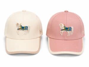 White and pink Soft Ride caps with embroidered horse logo, stylish and comfortable for sports and ca.