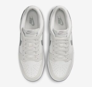 f16a12b8 | UAE SPORT STORE White Nike sneakers viewed from above, showing gray Nike Swoosh on each side and laced tongues.