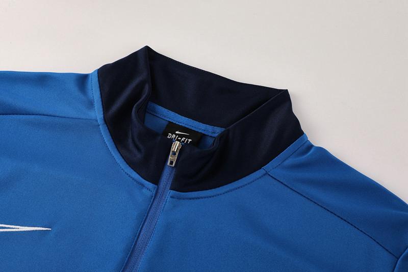 f176ad5e-c8d2-413e-ad55-f7a315454cb3 | UAE SPORT STORE Blue Nike Dri-FIT sports jacket with a navy collar and front zipper zipper up the center.
