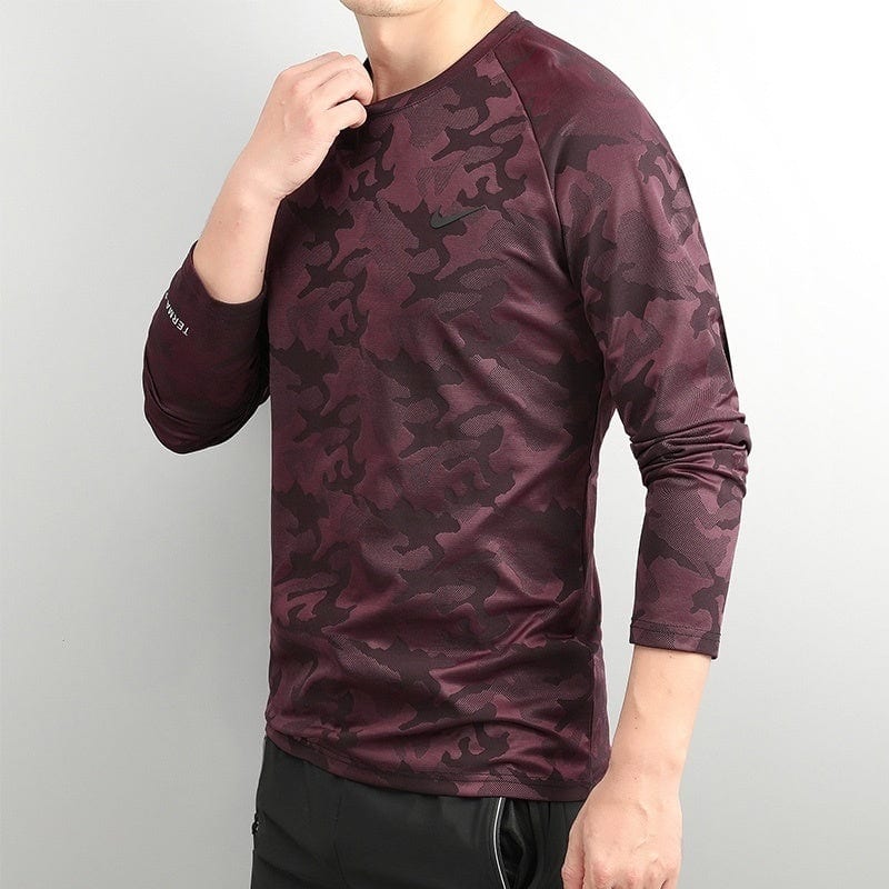f1946d0c | UAE SPORT STORE Man wearing burgundy camouflage long-sleeve athletic shirt, shown in side profile with hand at collar.