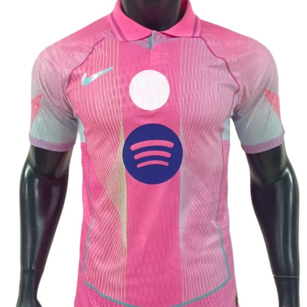Pink athletic polo-style soccer jersey on a mannequin, with a large Spotify logo across the chest and teal accents.