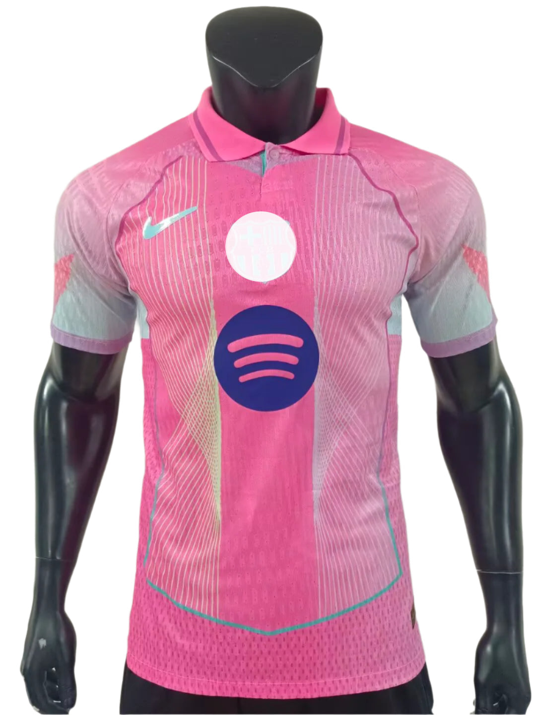 Pink athletic polo-style soccer jersey on a mannequin, with a large Spotify logo across the chest and teal accents.