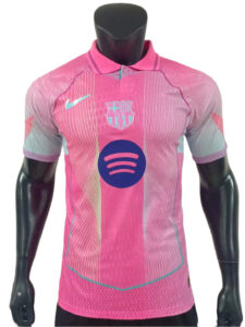 Pink FC Barcelona soccer jersey on a mannequin, featuring a Nike swoosh, club crest, and a Spotify logo on the front.