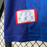 f1d4b784 | UAE SPORT STORE Close-up of a blue sports jersey with a red-bordered patch reading Official Merchandise and FFF logos.