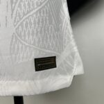 Close-up of white patterned fabric with a small black label that reads ENGINEERED.