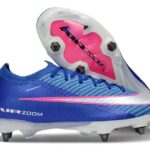 Blue Nike soccer cleat with pink swoosh and exposed pink Zoom Air plate on the sole, white studs visible at the bottom.