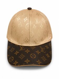 Beige LV monogram cap with light top and dark brown brim featuring the LV logo pattern all over.