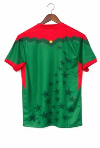 Back view of a red-and-green sports jersey on a wooden hanger, with a diagonal star pattern across the green body and red shoulders.