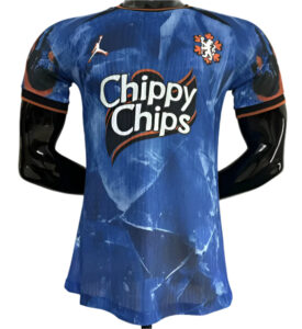 f348044d9aeb20fe | UAE SPORT STORE Blue athletic jersey featuring the 'Chippy Chips' sponsor logo and team crest on the chest, with a Puma logo and black sleeves with orange trim, displayed on a mannequin.