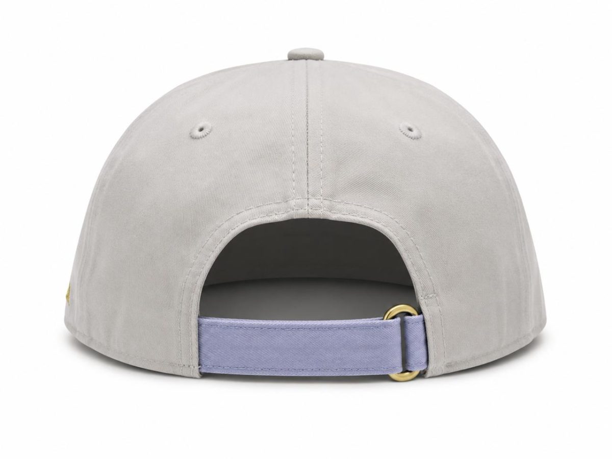 Light gray baseball cap viewed from the back, with an adjustable lavender strap and a gold buckle.