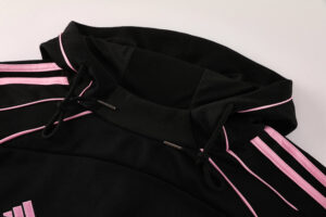 f44019a3 | UAE SPORT STORE Close-up of a black hoodie with pink piping along the hood and sleeves, and pink drawstrings.