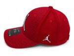 Red Jordan mesh cap with embroidered logo for sports and casual wear.