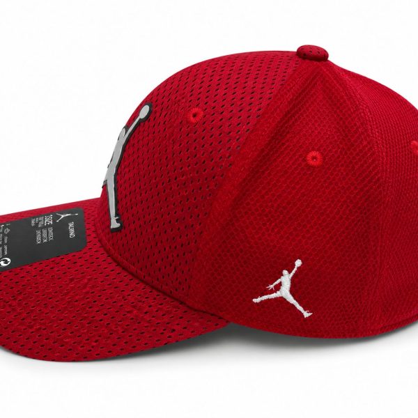 Red mesh baseball cap with a curved brim, featuring a white Jumpman silhouette on the side and a black tag on the brim edge.