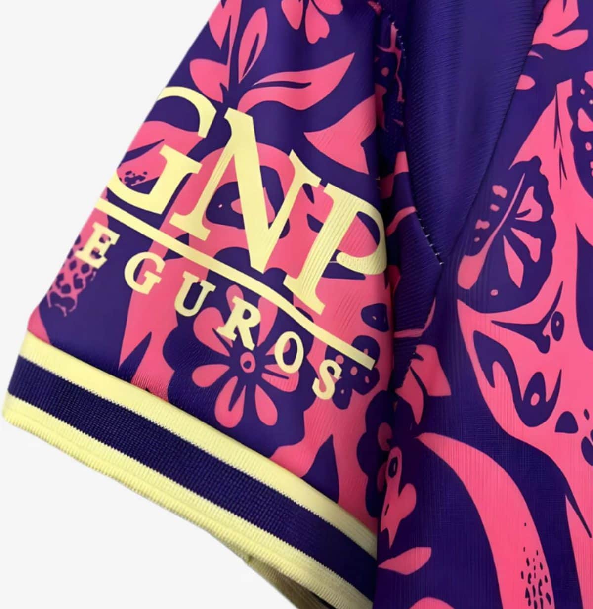 Close-up of a purple and pink floral garment sleeve with a yellow word logo along the sleeve edge.