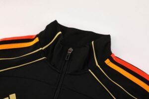 Black athletic jacket with a front zipper and orange stripe detailing along the shoulders and sleeves.