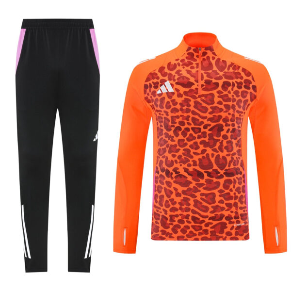 Athletic tracksuit: black joggers with pink side panels and a bright orange leopard-print long-sleeve top.