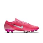 Pink Nike soccer cleat with silver swoosh and studded outsole, shown from side profile.