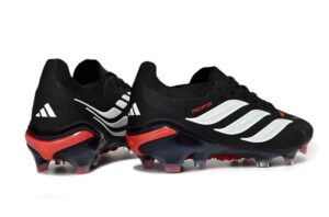 f5087a32-b23a-4ad3-90e3-6bb700618f23 | UAE SPORT STORE Black Adidas Predator soccer cleats with white stripes and red outsole, side view