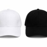 White and black baseball caps shown side by side on a white background, front view with curved bills