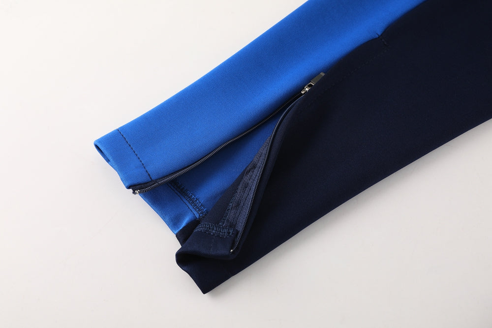 f557a139 | UAE SPORT STORE Two-tone fabric sleeve (blue and navy) with a zipper, folded on a light surface.