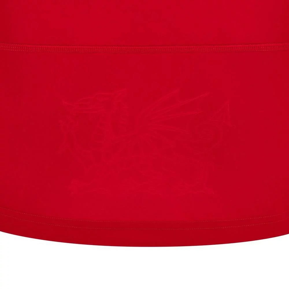 f5ba5d590879dc5a8e28d14075c3e416 | UAE SPORT STORE Close-up of red fabric showing stitching and a faint, indistinct graphic or watermark