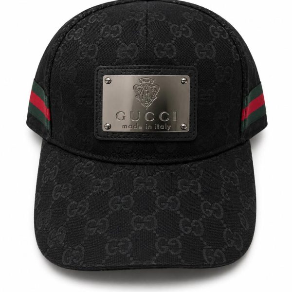 Black Gucci cap with interlocking GG pattern and a silver front plaque reading 'Gucci made in Italy'.