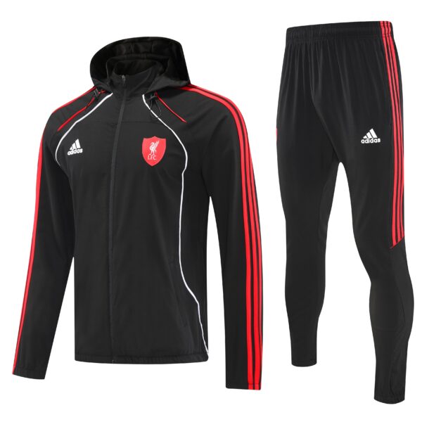 Black Liverpool FC tracksuit jacket with red piping and crest, paired with black pants featuring red Adidas stripes and logo.