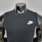 Chrome mannequin torso wearing a dark Nike sleeveless shirt with a white Nike swoosh logo on the chest.
