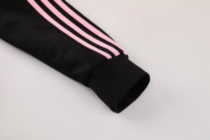 f94f84ec | UAE SPORT STORE Black athletic sleeve with pink stripes and a ribbed cuff, close-up detail of a sports jacket