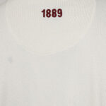 Beige fabric with red embroidered number '1889' near the collar area.