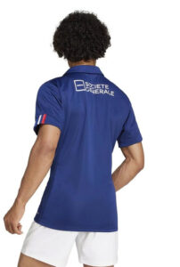 Back view of a person in a blue polo shirt with the Societe Generale logo on the upper back, white shorts visible at the bottom.