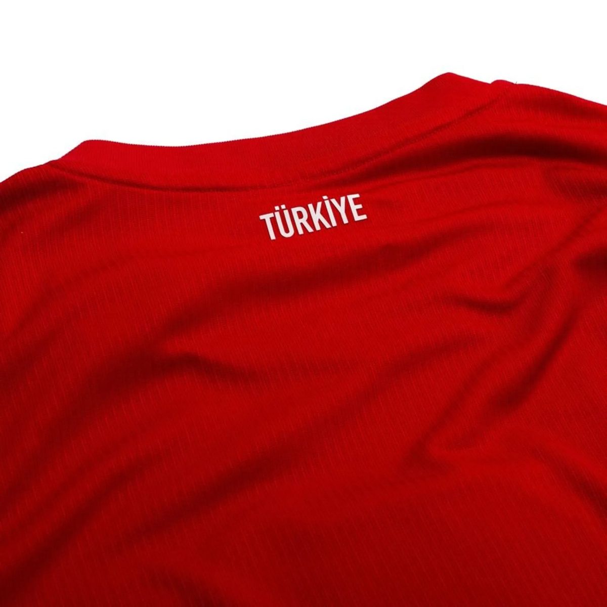 Close-up of red fabric with white text reading 'TÜRKİYE'.