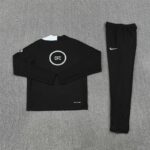 Black long-sleeve training top with white neck lining and a circular CFC logo on the back, paired with black athletic pants featuring a white Nike swoosh.